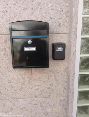 a clock on the side of a wall with a box at Delizioso appartamento in Rome