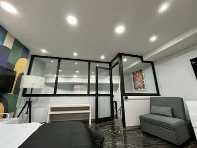 a bedroom with a bed and a chair at Delizioso appartamento in Rome