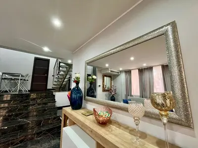 a bathroom with a large mirror and a counter at Delizioso appartamento in Rome