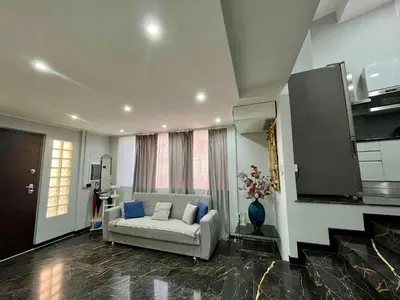a living room with a white couch and a window at Delizioso appartamento in Rome