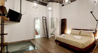 a bedroom with a bed and a tv in it at Loft 133 - Central and Luxury Loft in Rome in Rome