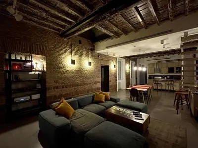 a living room with a couch and a brick wall at Loft 133 - Central and Luxury Loft in Rome in Rome