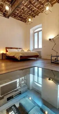 a bedroom with a bed and a swimming pool at Loft 133 - Central and Luxury Loft in Rome in Rome