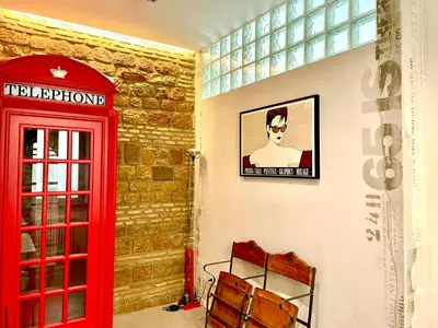 a red phone booth and a red telephone box at Loft 133 - Central and Luxury Loft in Rome in Rome