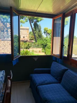 a living room with a blue couch and windows at Villa Elena in Rome