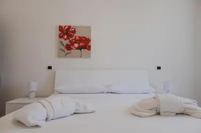 a white bed with two white towels on it at Appartamento San Giovanni Liliana in Rome