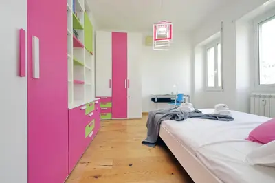 a room with a bed and a pink cabinet at 4BNB - Trionfale Apartment in Rome