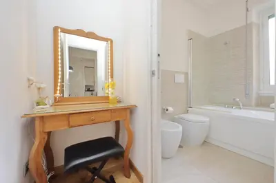 a bathroom with a wooden vanity and a mirror at 4BNB - Trionfale Apartment in Rome