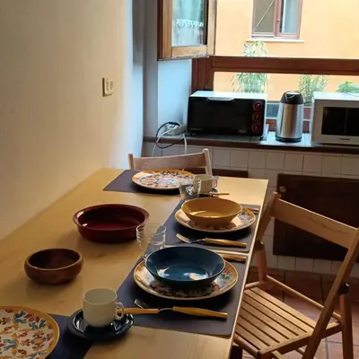 a table with plates and bowls on top of it at La Casa di Filippo in Rome