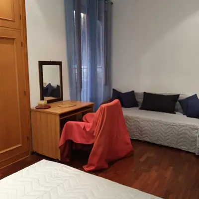a room with a couch and a table and a mirror at La Casa di Filippo in Rome