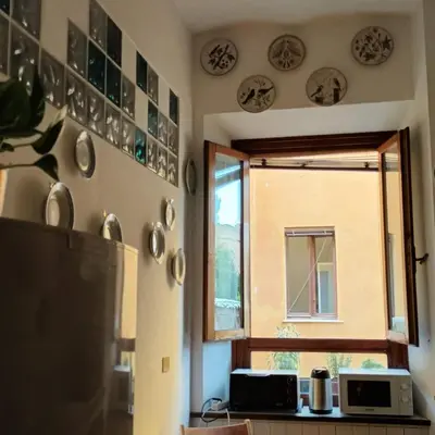 a kitchen with a window and plates on the wall at La Casa di Filippo in Rome