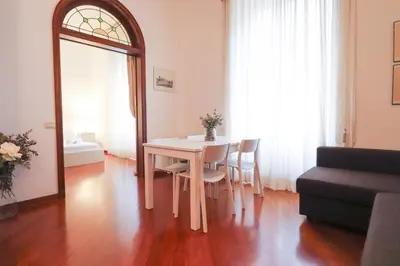 a table and chairs in a living room with a mirror at A 10 passi dal Vaticano in Rome