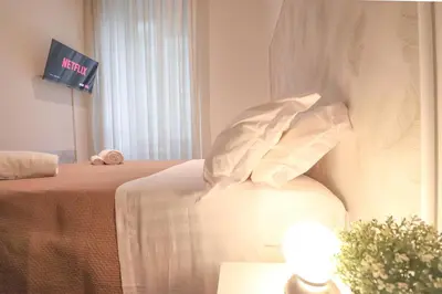 a hotel room with a bed with pillows and a tv at A 10 passi dal Vaticano in Rome