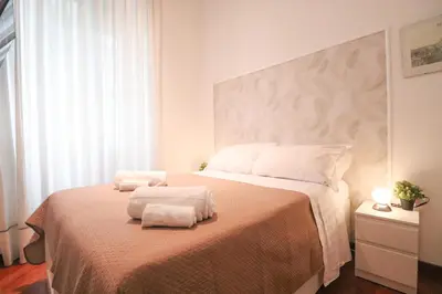 a bedroom with a bed with two towels on it at A 10 passi dal Vaticano in Rome