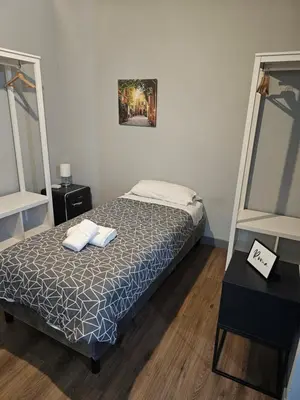 a bedroom with a bed with two towels on it at Trastevere Guestrooms in Rome