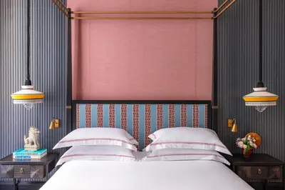 a bedroom with a white bed with a red headboard at Palazzo Roma - The Leading Hotels of the World in Rome