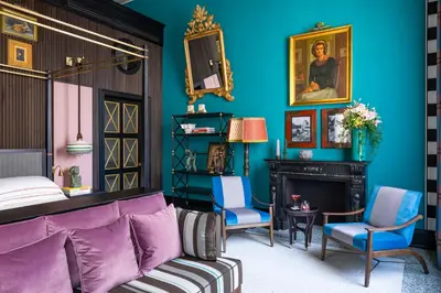 a bedroom with blue walls and a bed and a fireplace at Palazzo Roma - The Leading Hotels of the World in Rome