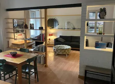 a living room with a table and a couch at Monti Parioli House in Rome