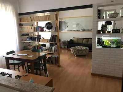 a living room with a table and a dining room at Monti Parioli House in Rome