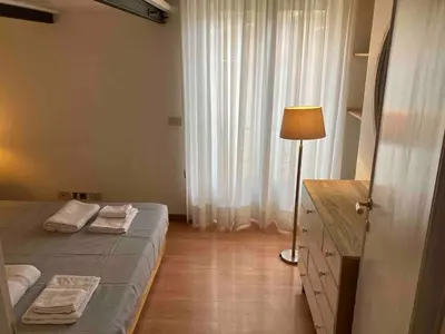 a bedroom with a bed and a lamp and a window at Monti Parioli House in Rome