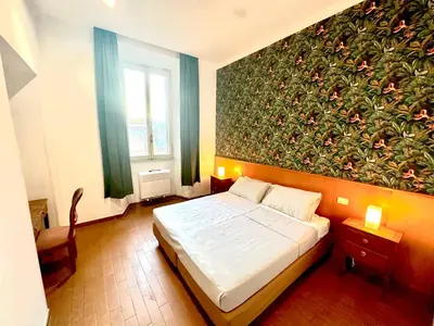 a bedroom with a bed and a large floral wall at Trevi Romantic Alcova in Rome