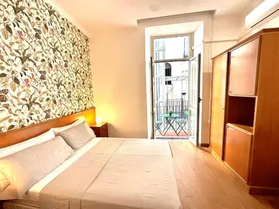 a bedroom with a large bed and a window at Trevi Romantic Alcova in Rome
