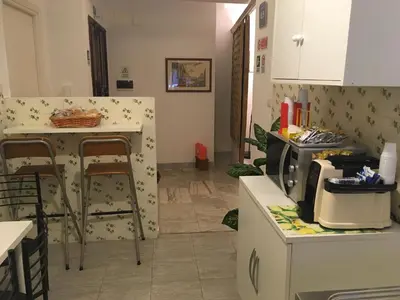 a kitchen with a counter and some chairs in it at Residenza Flaminia in Rome