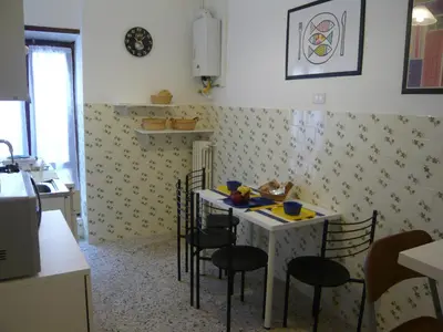 a kitchen with a table and chairs in a room at Residenza Flaminia in Rome