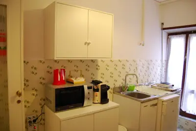 a small kitchen with a microwave and a sink at Residenza Flaminia in Rome