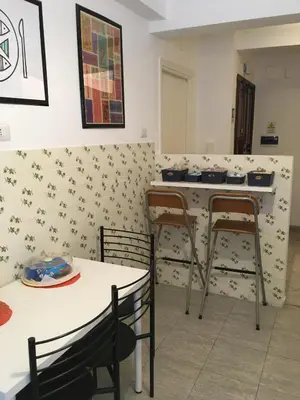 a kitchen with two tables and two chairs and a counter at Residenza Flaminia in Rome