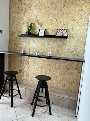 a bar with two stools in front of a wall at Signorina In Rome in Rome