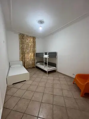 a room with a room with a bed and a table at Signorina In Rome in Rome