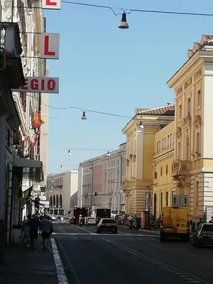 a city street with people walking down the street at Signorina In Rome in Rome