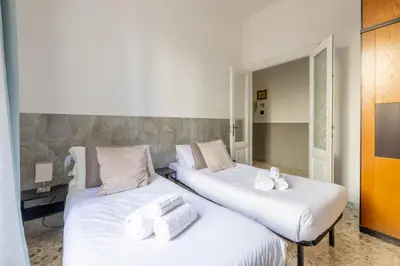 two beds in a room with white towels on them at Vatican Stylish by Varental - Guardabassi Collection in Rome
