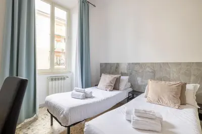two beds in a room with a window at Vatican Stylish by Varental - Guardabassi Collection in Rome