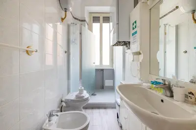 a white bathroom with a sink and a toilet at Vatican Stylish by Varental - Guardabassi Collection in Rome