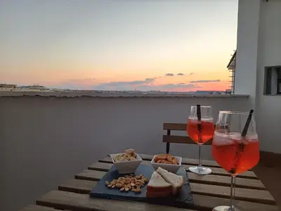 a table with two glasses of wine and a tray of food at DOMUS VACANZE ROMANE in Rome
