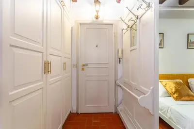 a hallway with white doors and a bed in a room at Al cortile del Moro in Rome