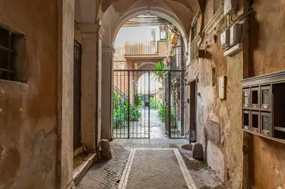 an alley with an archway in an old building at Al cortile del Moro in Rome