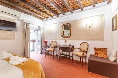a bedroom with a table and a dining room at Al cortile del Moro in Rome
