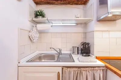 a small kitchen with a sink and a counter at Al cortile del Moro in Rome