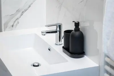 a bathroom sink with a black soap dispenser on it at La Dolce Vita Boutique Guest House in Rome