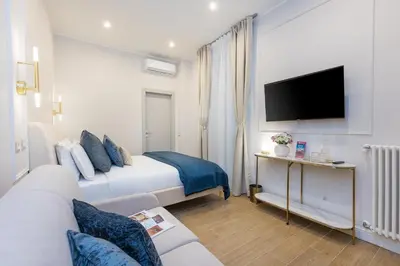 a hotel room with a bed and a tv at La Dolce Vita Boutique Guest House in Rome