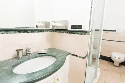 a bathroom with a sink and a toilet at Baccina Inn in Rome