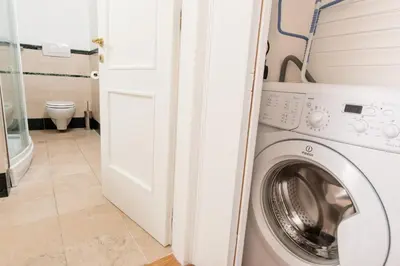 a laundry room with a washer and dryer at Baccina Inn in Rome