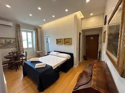 a bedroom with a large bed and a table at Manzoni Blue House by GHOR in Rome