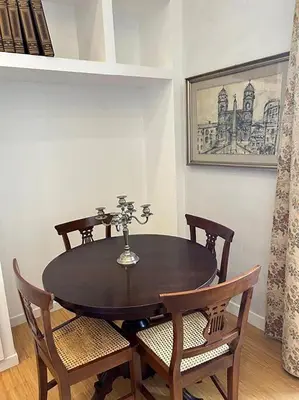 a dining room with a table and chairs and a picture at Manzoni Blue House by GHOR in Rome