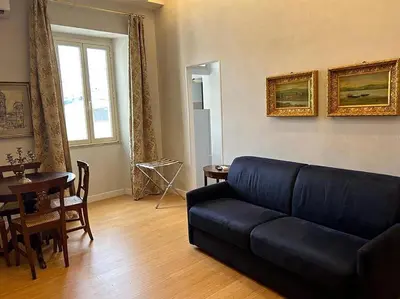 a living room with a couch and a table at Manzoni Blue House by GHOR in Rome