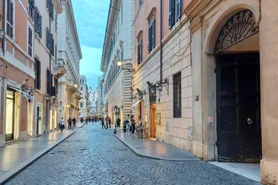 a cobblestone street in a city with buildings at Fontanella Borghese CORI apartment in Rome