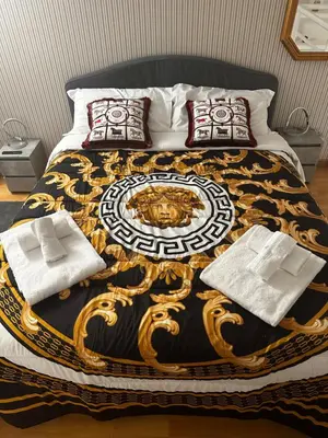 a bed with a black and gold blanket on it at PARIOLI LUXURY SUITe II in Rome